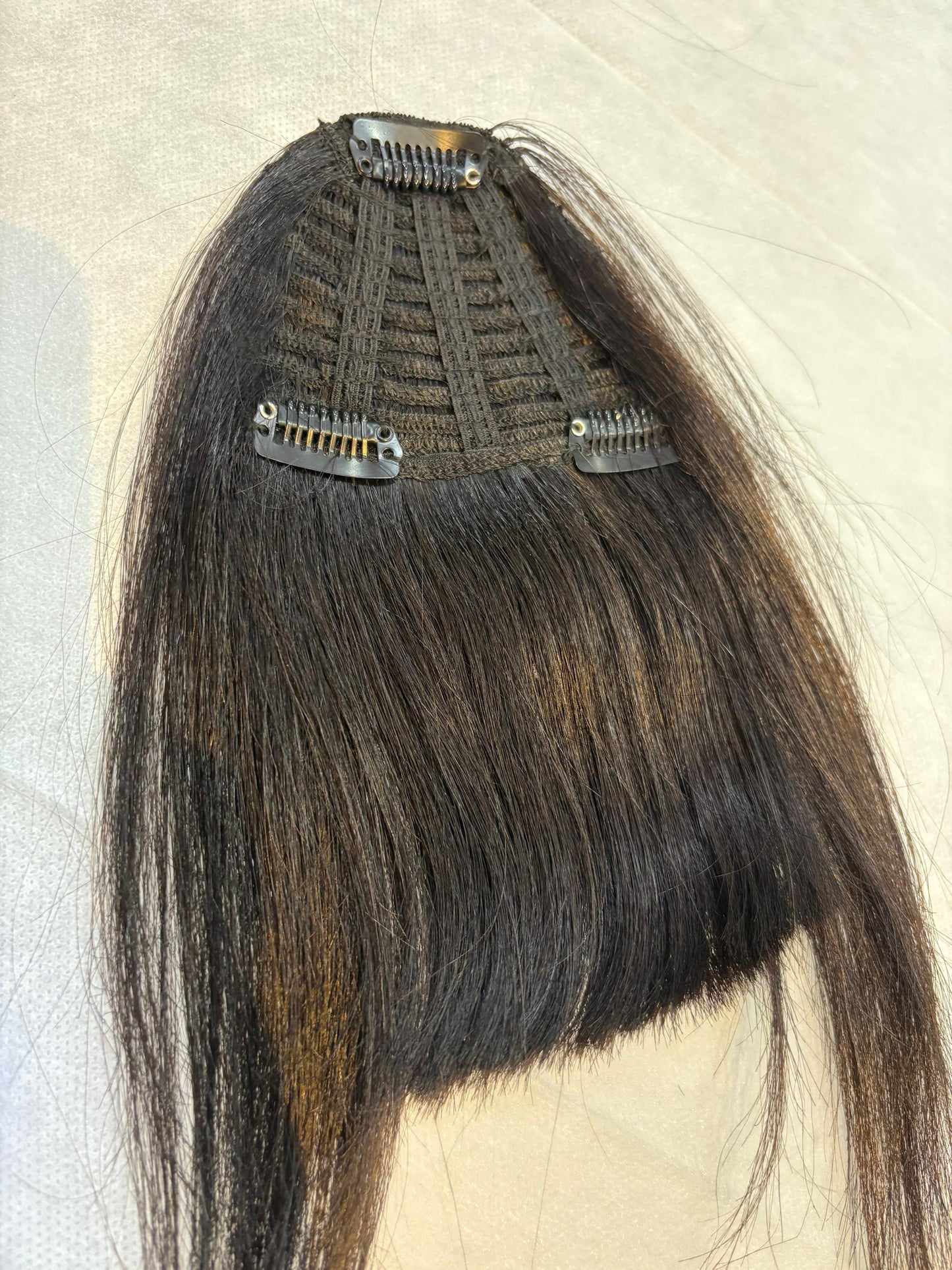 Hair extension with clips on a neutral background