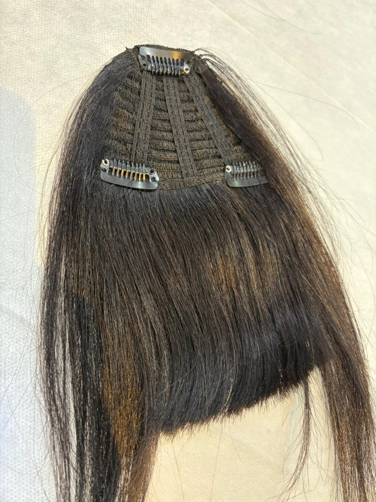 Hair extension with clips on a neutral background