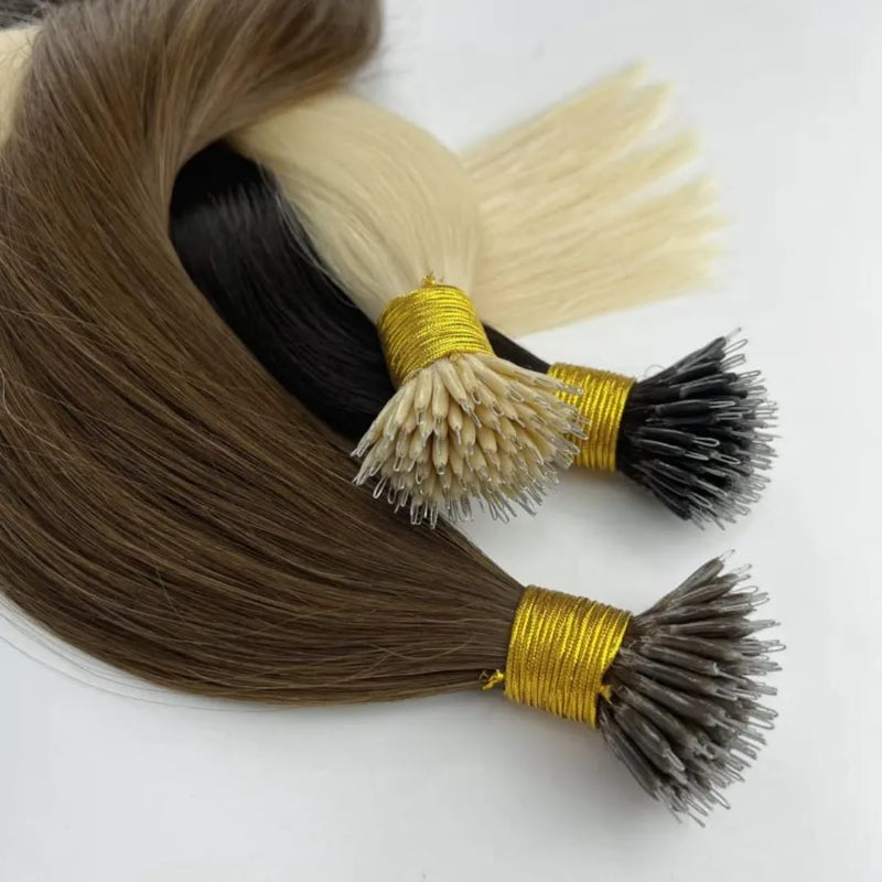 Hair extensions in brown, blonde, and gray on a white background